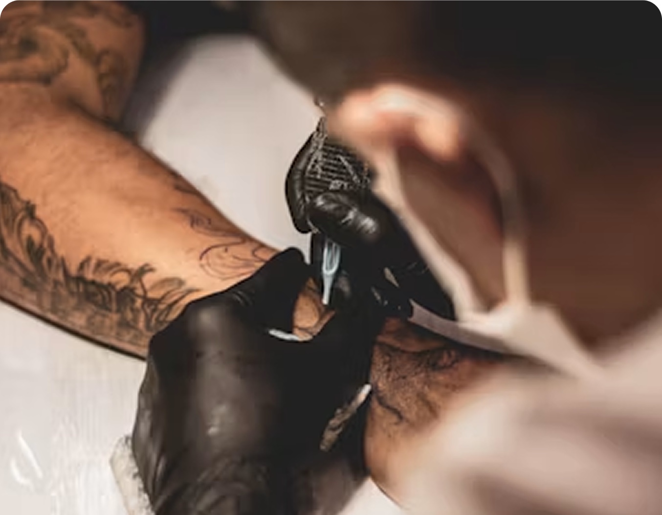 A tattoo artist mid-session