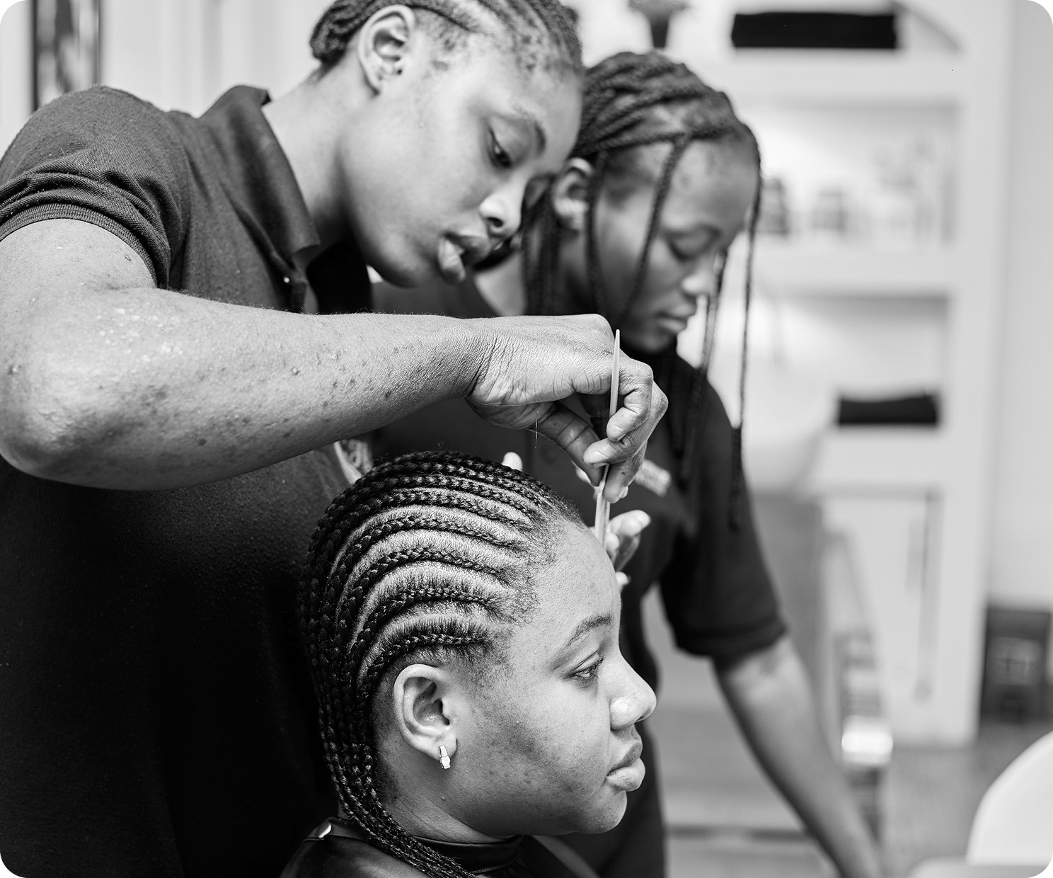 A stylist braiding a client's hair